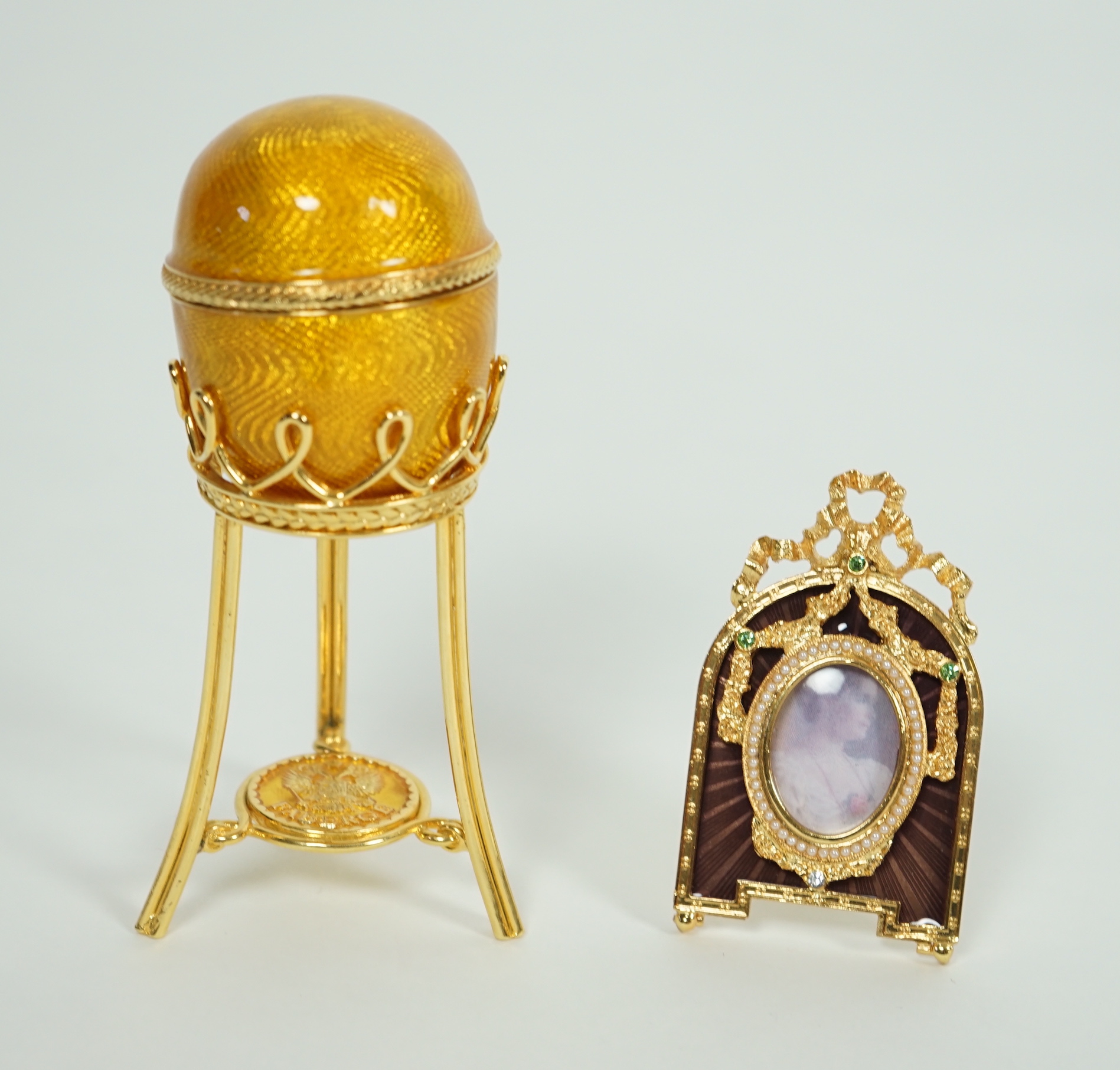 A Fabergé Imperial Collection Menagerie Rabbit Surprise Egg on stand together with a Fabergé gilt and enamel photograph frame